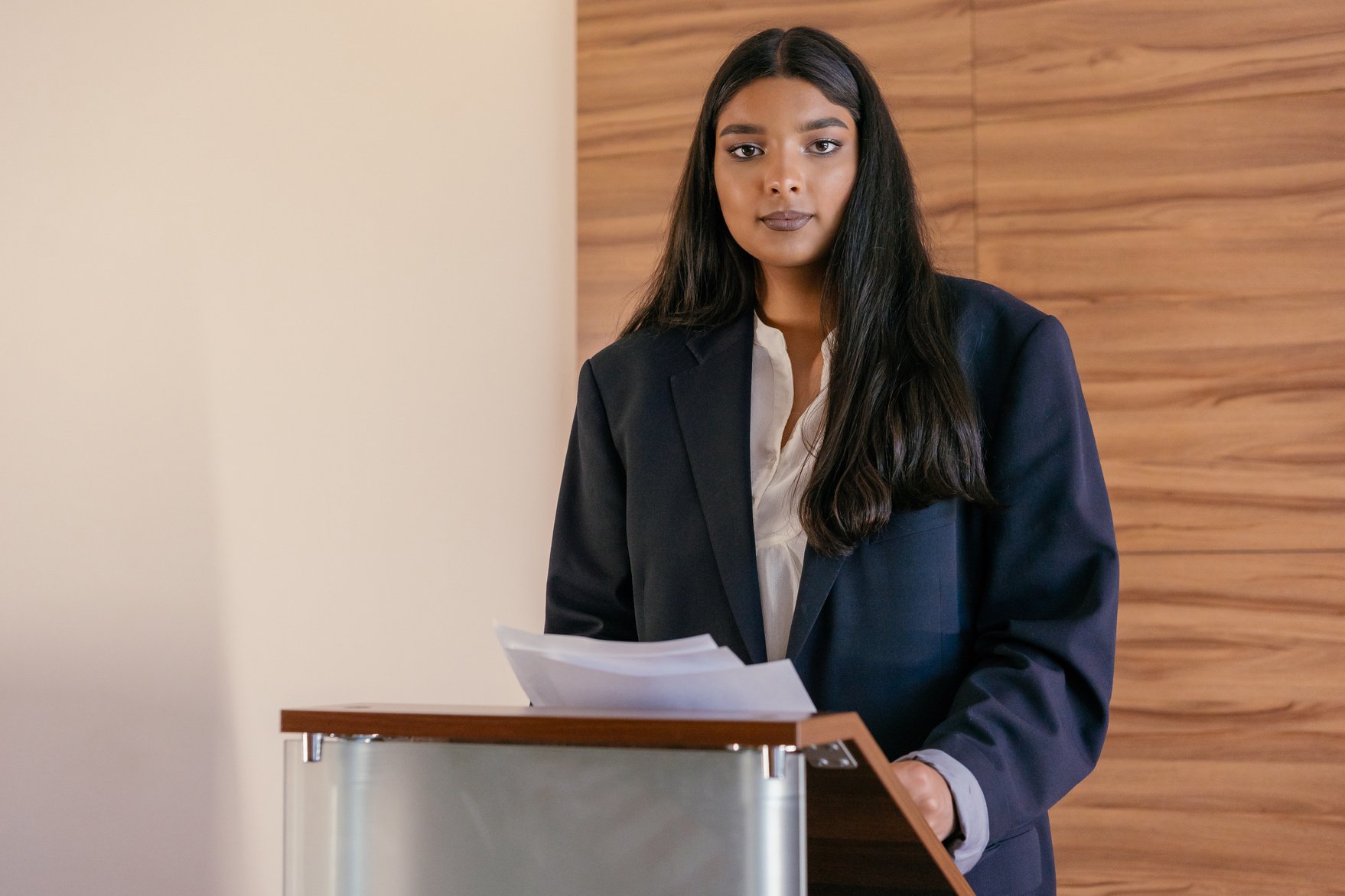 Woman Standing Behind Speech Desk